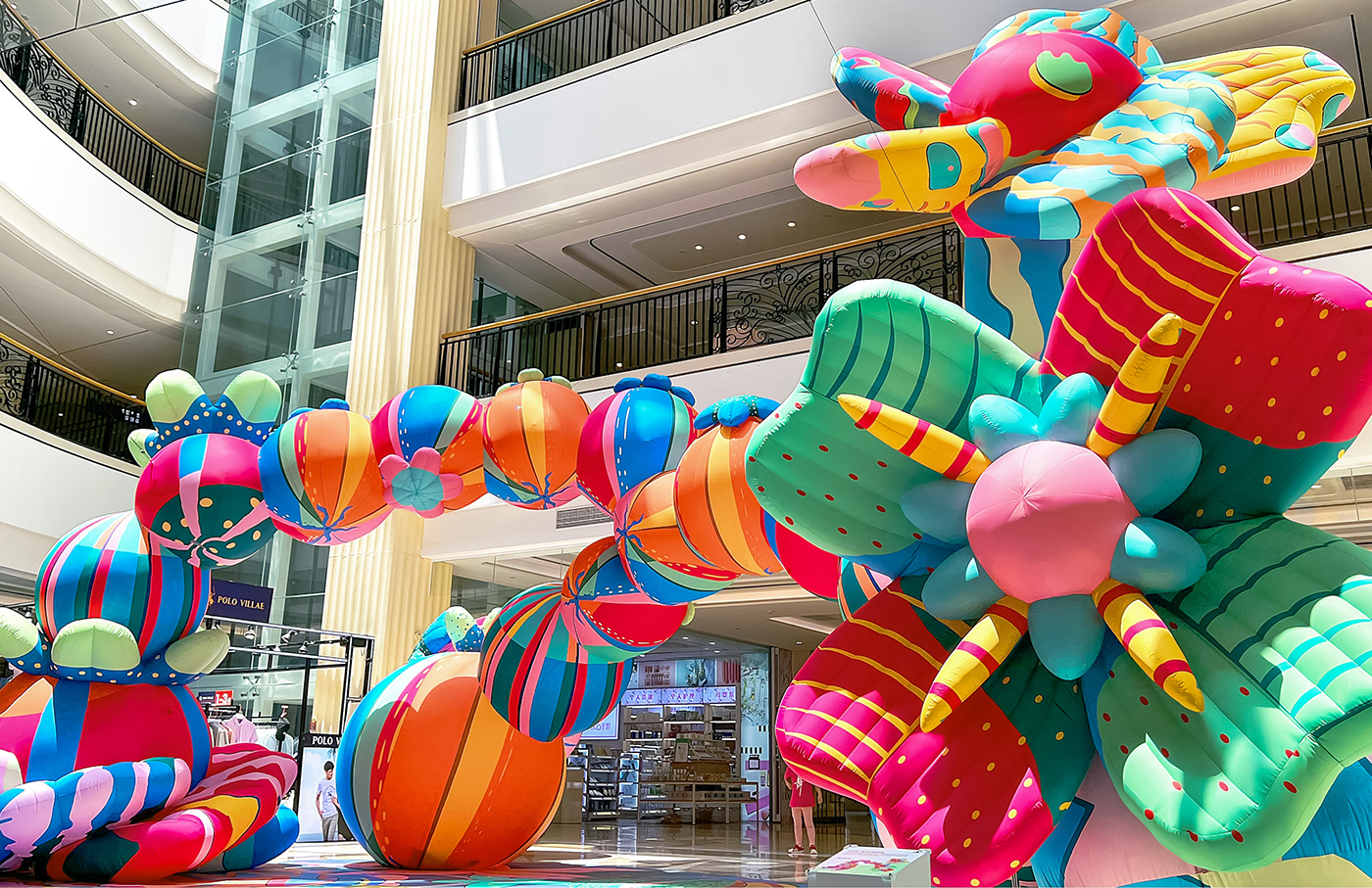A giant inflatable instillation designed by Sam Wilde made of colourful fruit and flower sculptures.