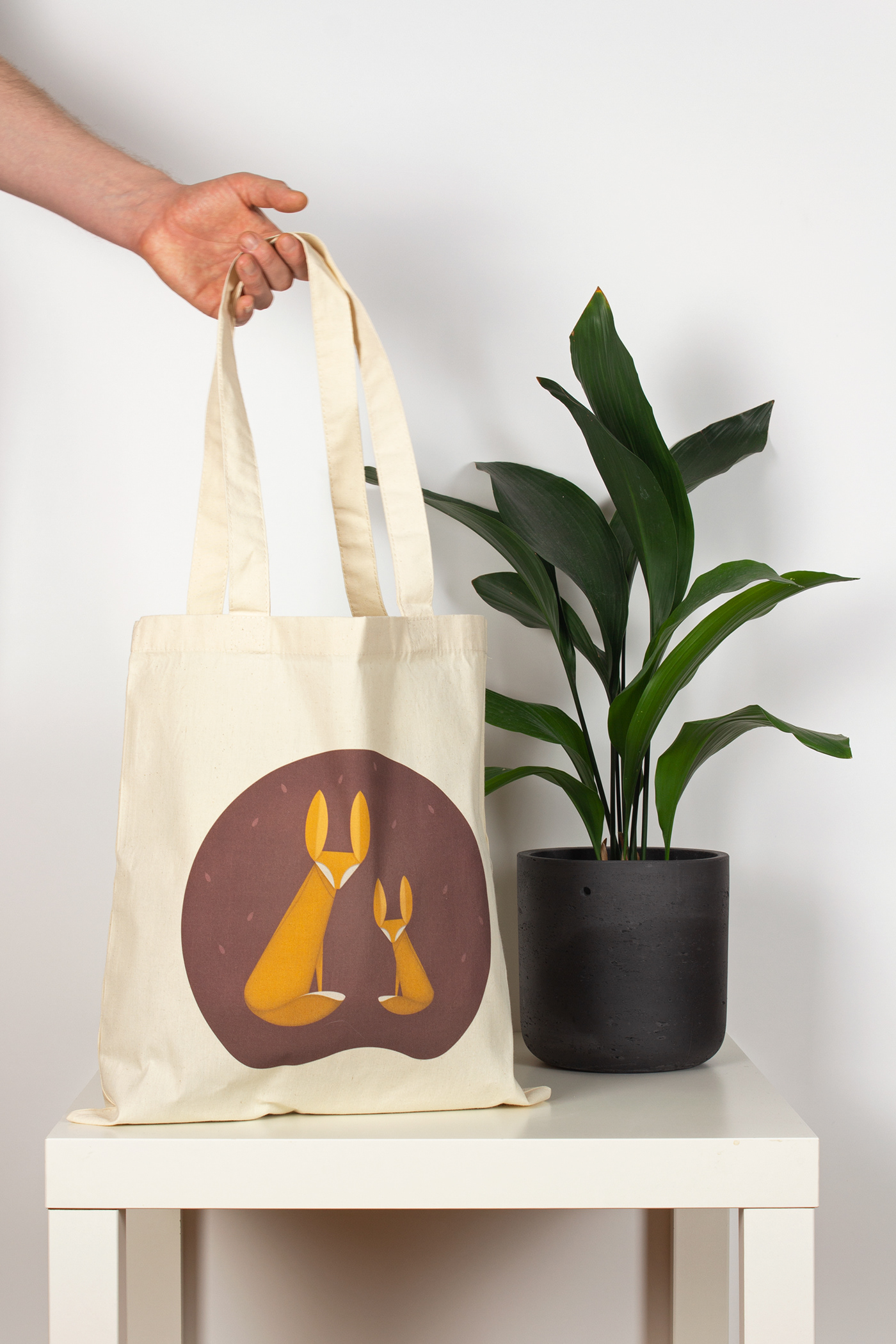 Foxes illustration printed on natural cotton bag.