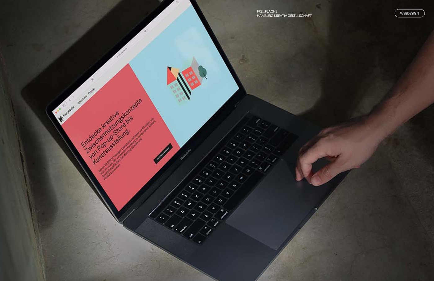macbook desktop mockup with a colorful homepage in a industrial setting 