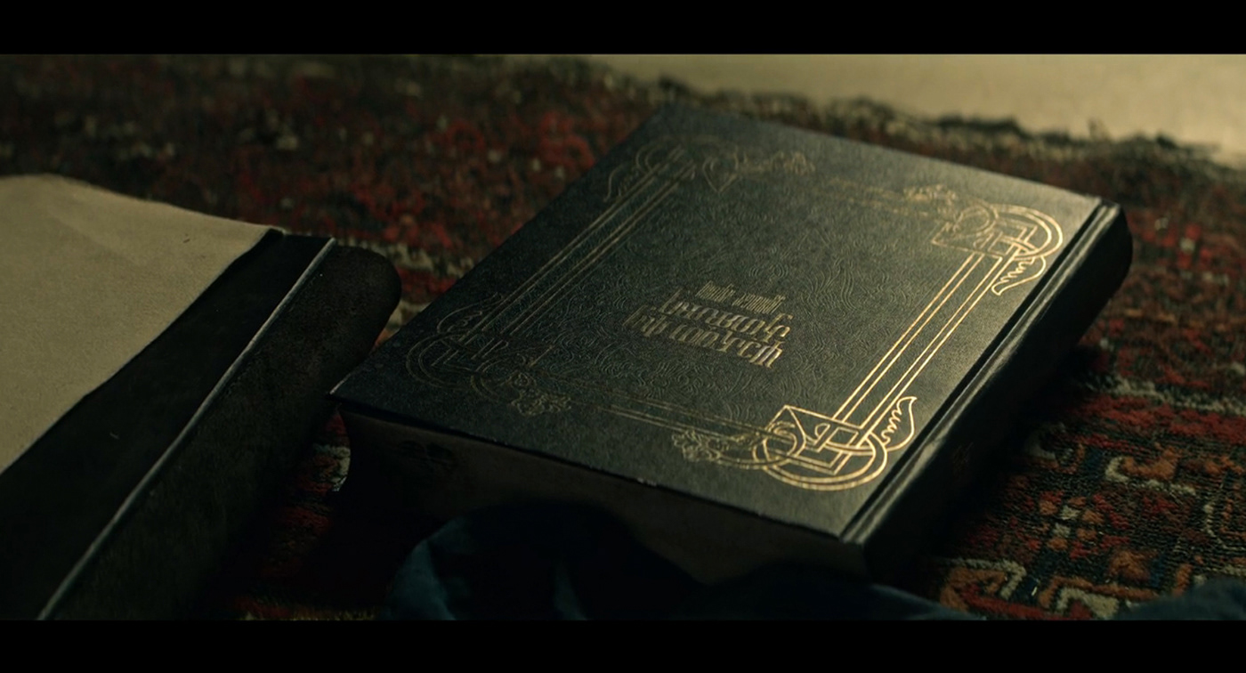 A still image from the netflix series Shadow and Bone with a chlidren’s book in Keramzin
