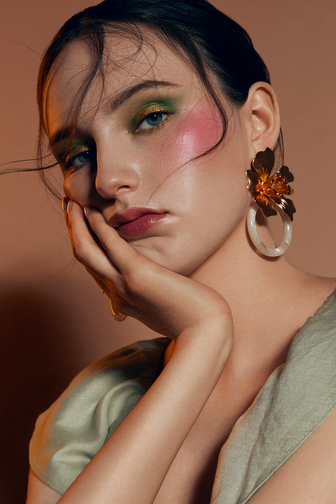 Editorial beauty photography publication, natural skin retouching and creative makeup, gold earrings