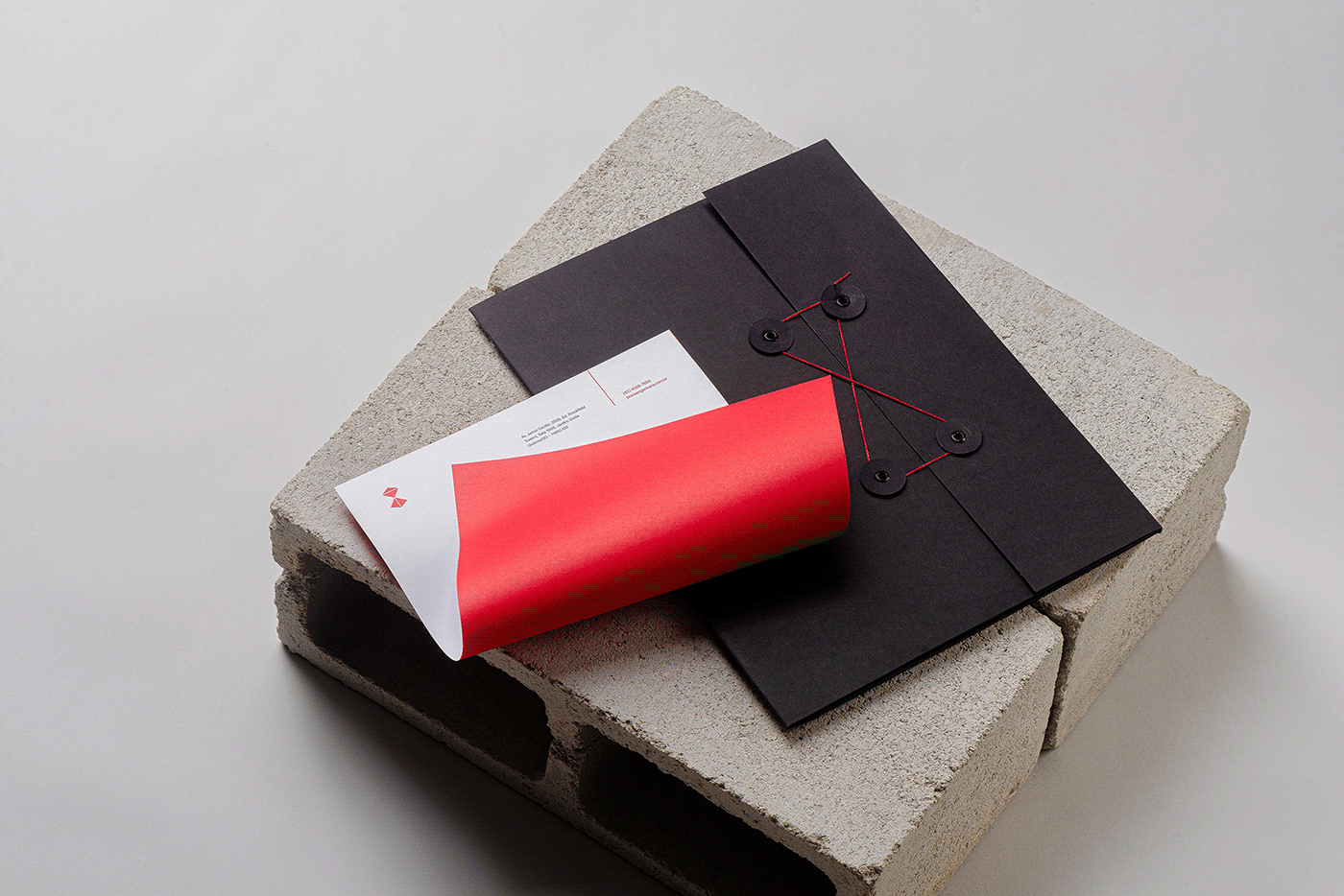 Brava, BRBAUEN, letterhead and folder on top of a cement brick
