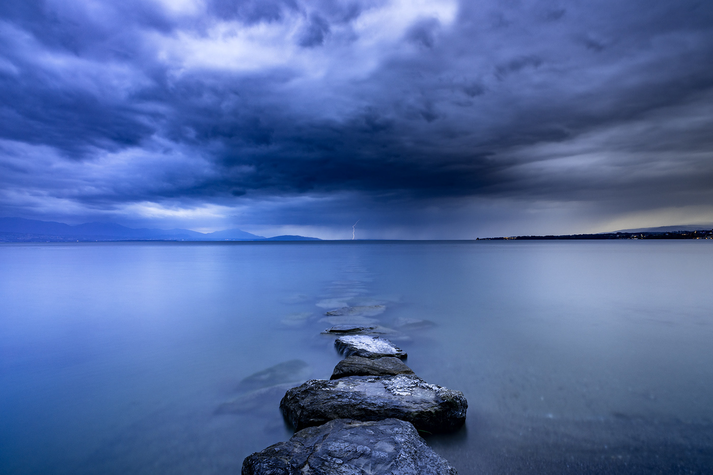 Dramatic and moody landscape photography of lake Geneva by Jennifer Esseiva.