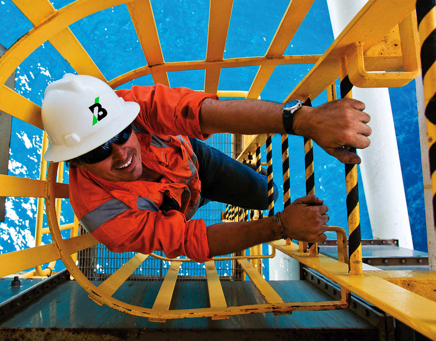 Buel - Brand identity mining services - worker climbing ladder at oil rig