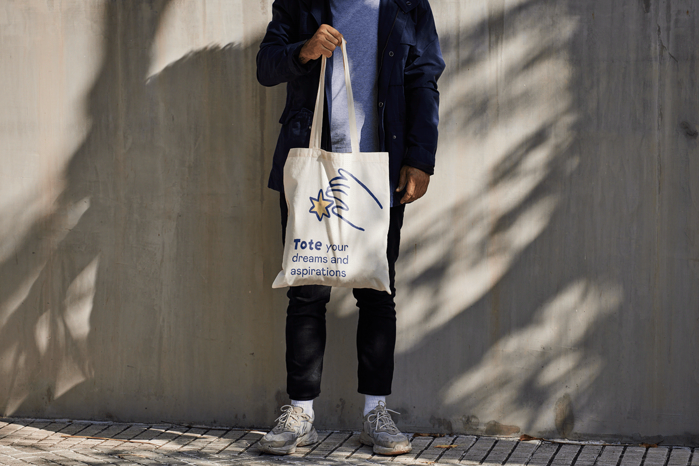 Man holding a branded tote bag