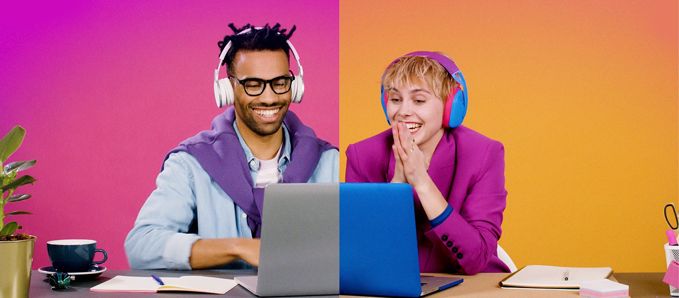 Two people on laptops excited about learning a new language
