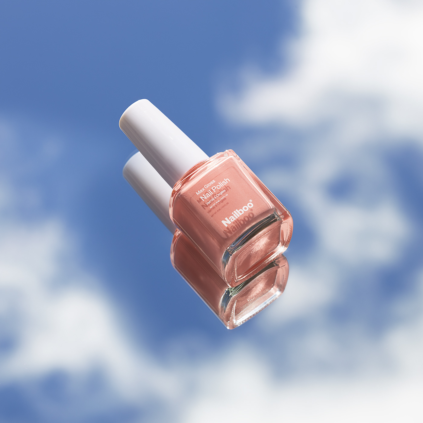 nail polish on the background of the spring sky with clouds