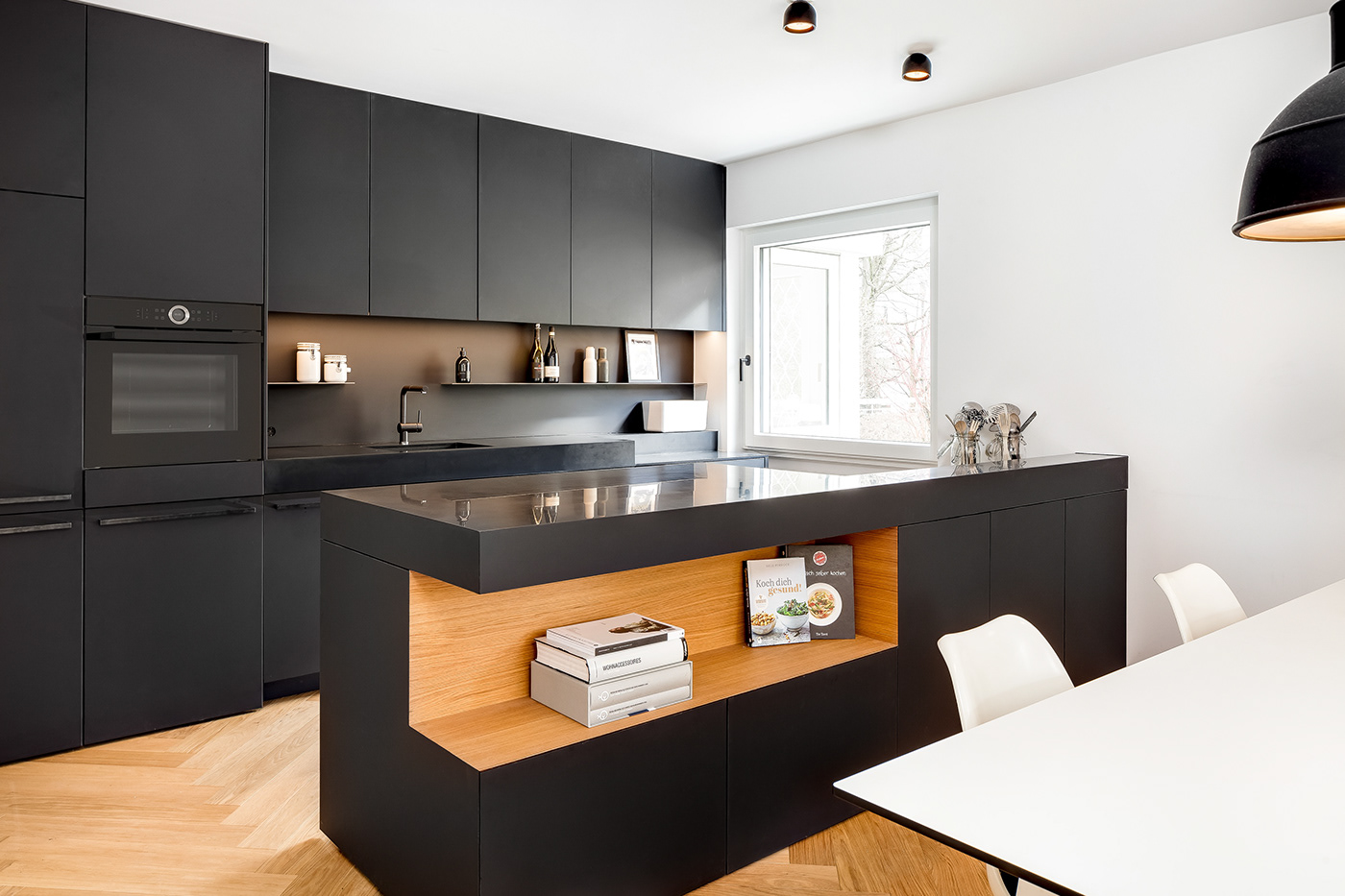 schwarze Küche mit block und offenem design Element in eiche 
