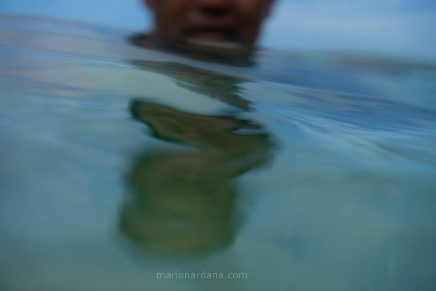an image of a man reflected in the sea