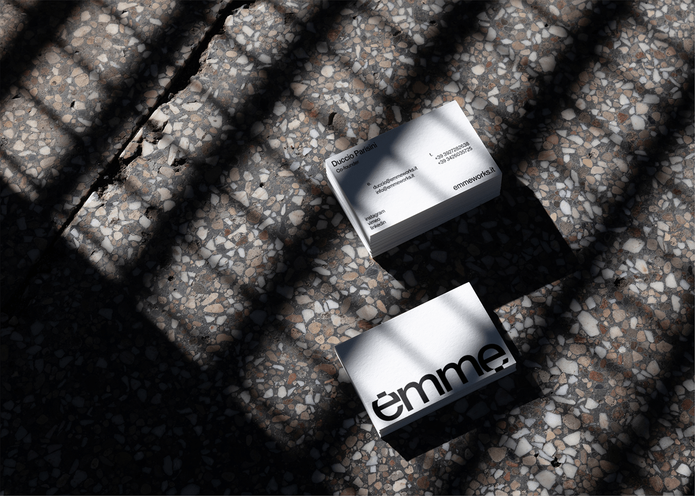 emme business card in the floor with shadows