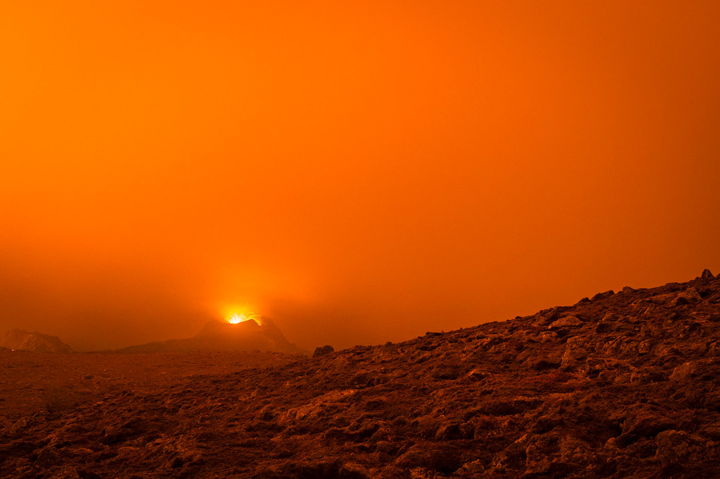The nightly lava dips the landscape in an extraterrestrial orange