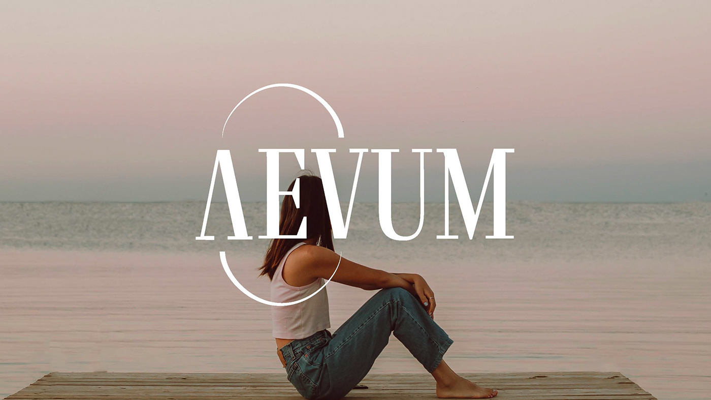 brand logo for "Aevum" in white over an image of a woman sitting on a dock looking at water