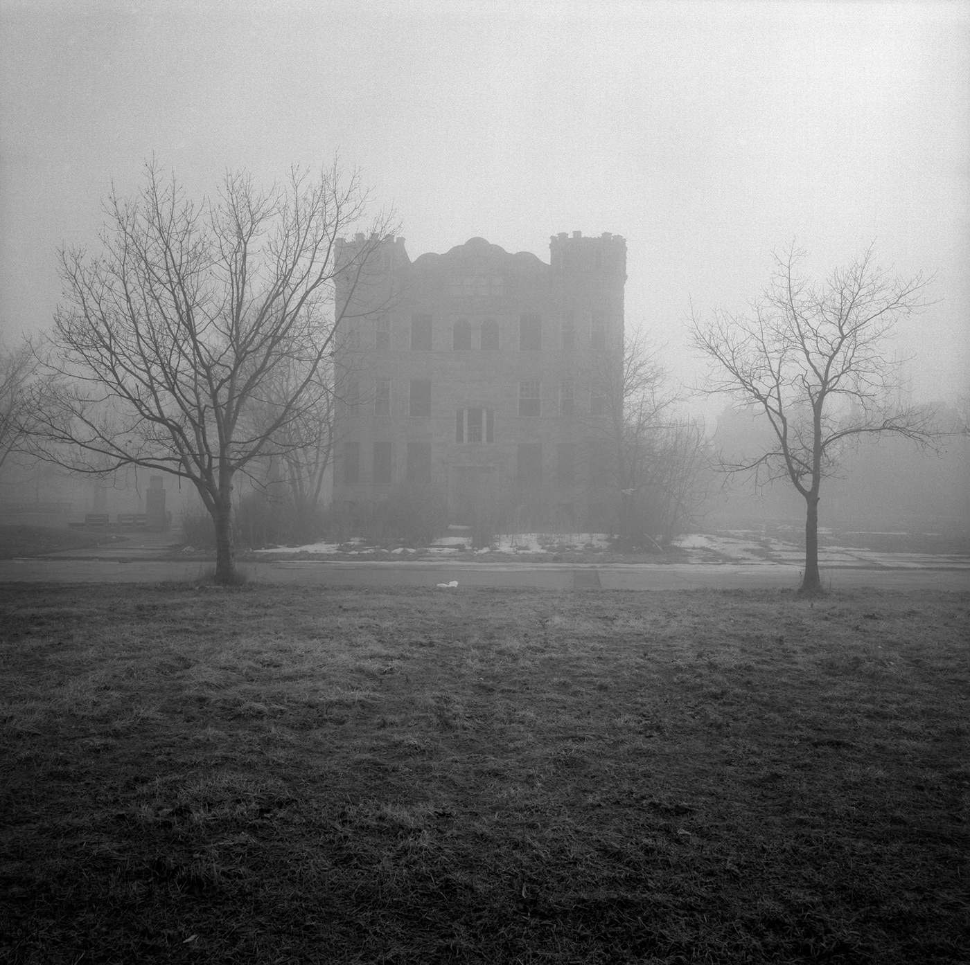An old castle-like house, in the fog, in Detroit, Michigan.
