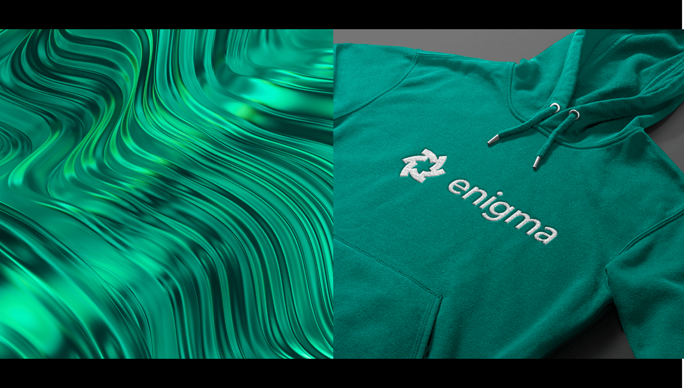 green sweatshirt with enigma logo embroidery lies on a horizontal surface, abstract green background