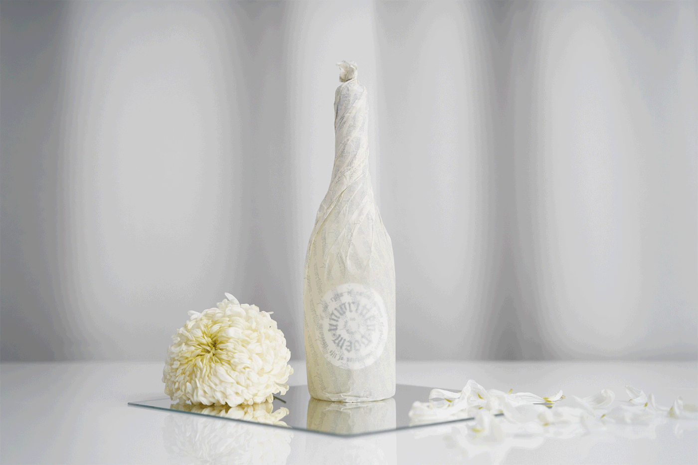 Bottle of sparkling white wine sitting on a top of a table 