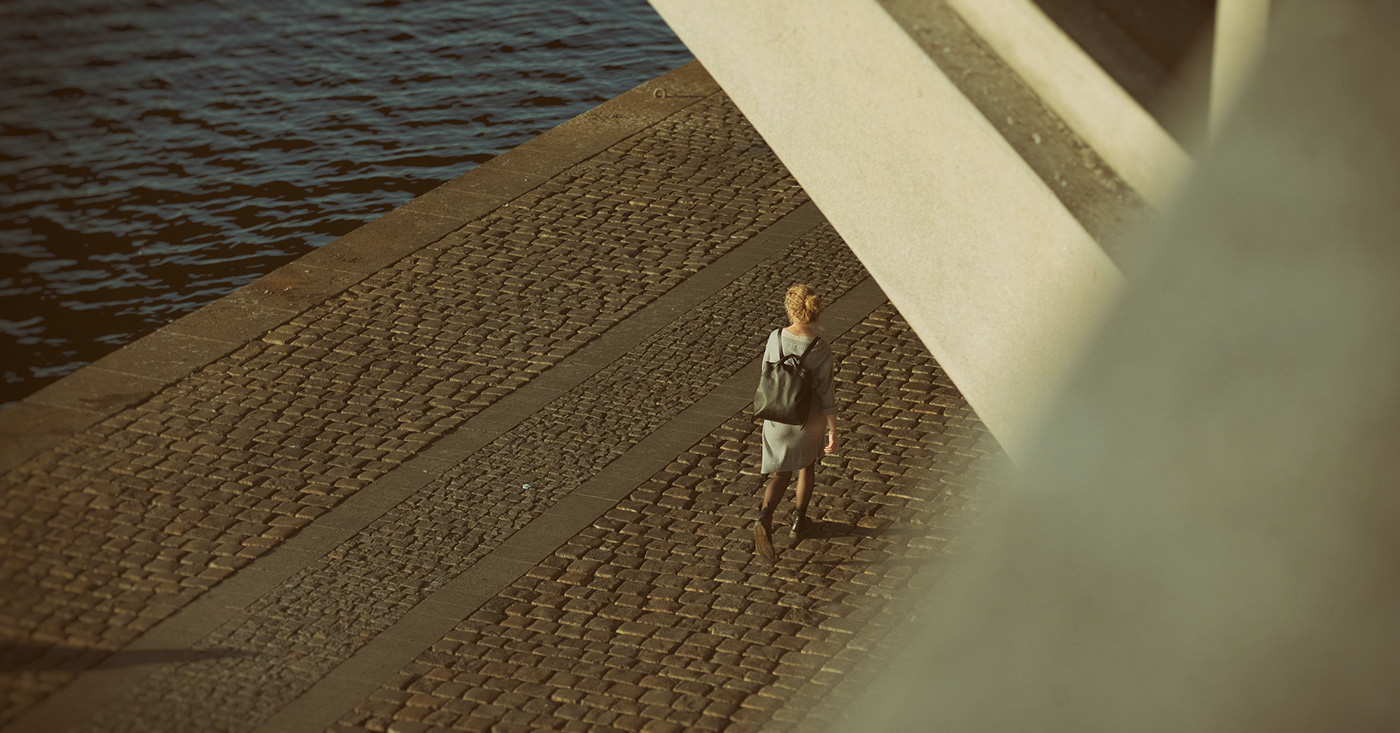 Woman walking on the river bank. Prague. Czech Republic