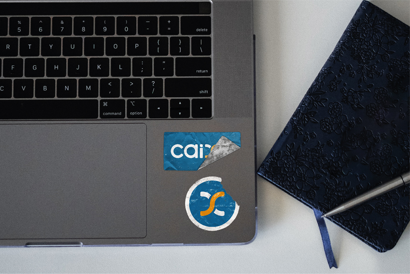 Caixa's stickers in a Macbook, the stickers are bruised and look old