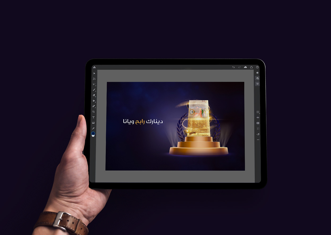 designer holds ipad pro in hands with Adobe photoshop on the ipad opend
