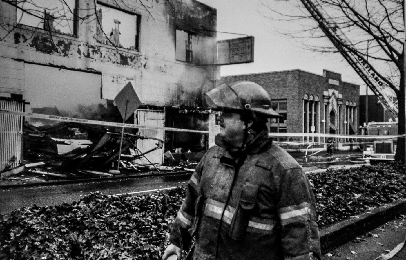 firefighter looks on at a fires aftermath