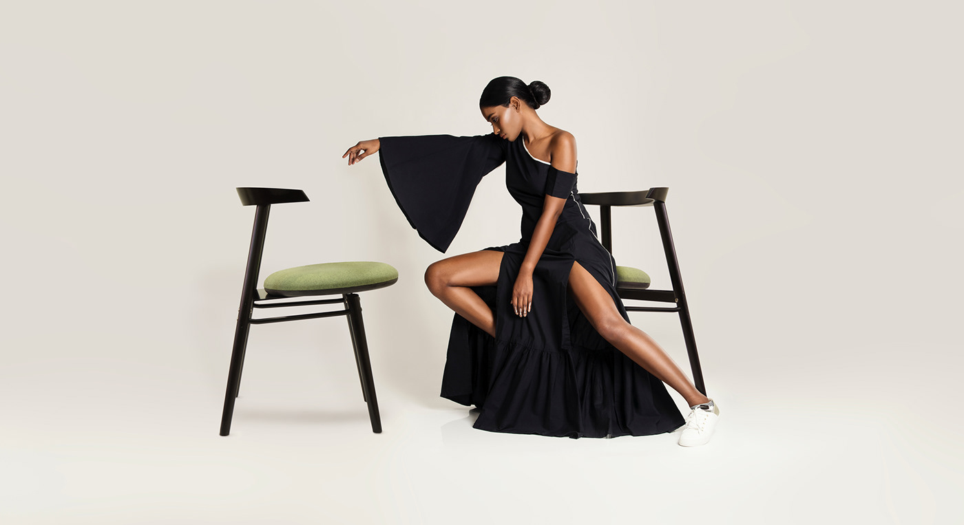 model sitting on Islero dining chair by Troy Backhouse