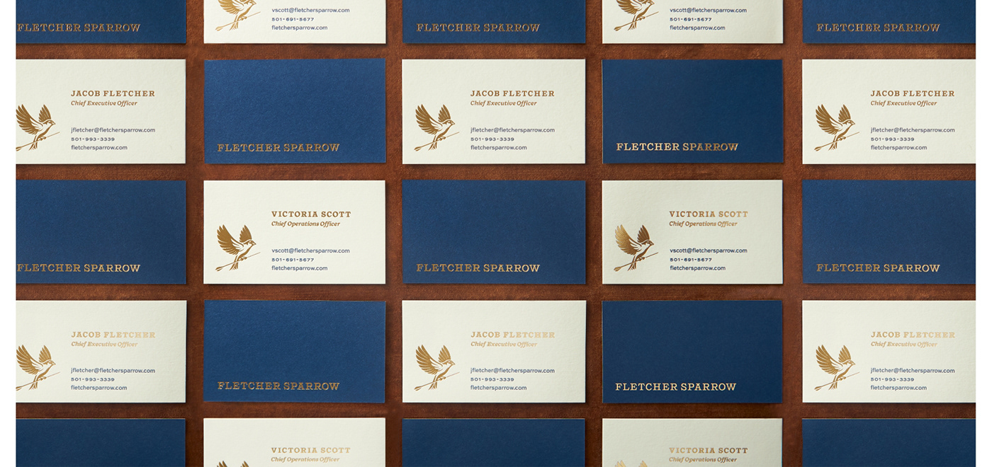 The executive team's business cards are crafted from matte brass foil and letterpress printed.