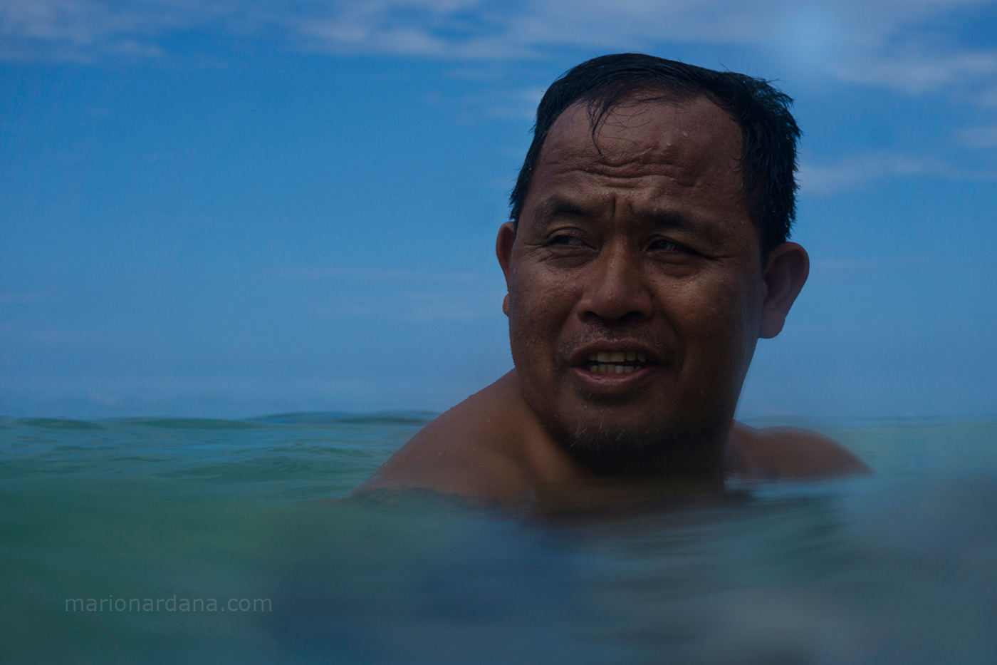 A portrait of a man submerged in the water.