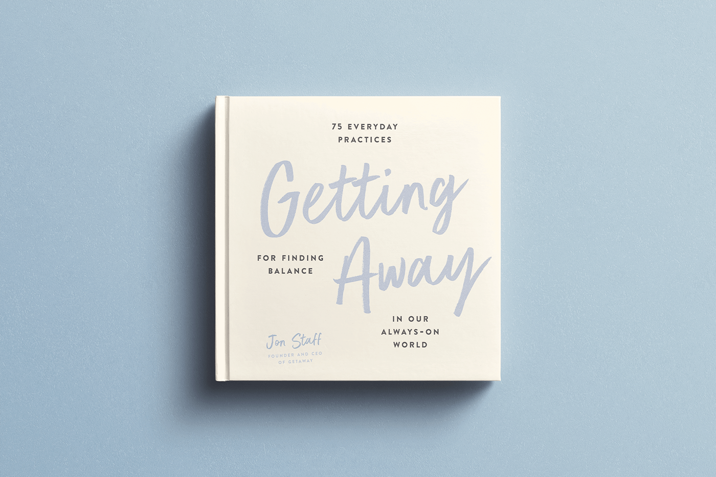 A mock up of the Getting Away book laying flat on a  blue background. 