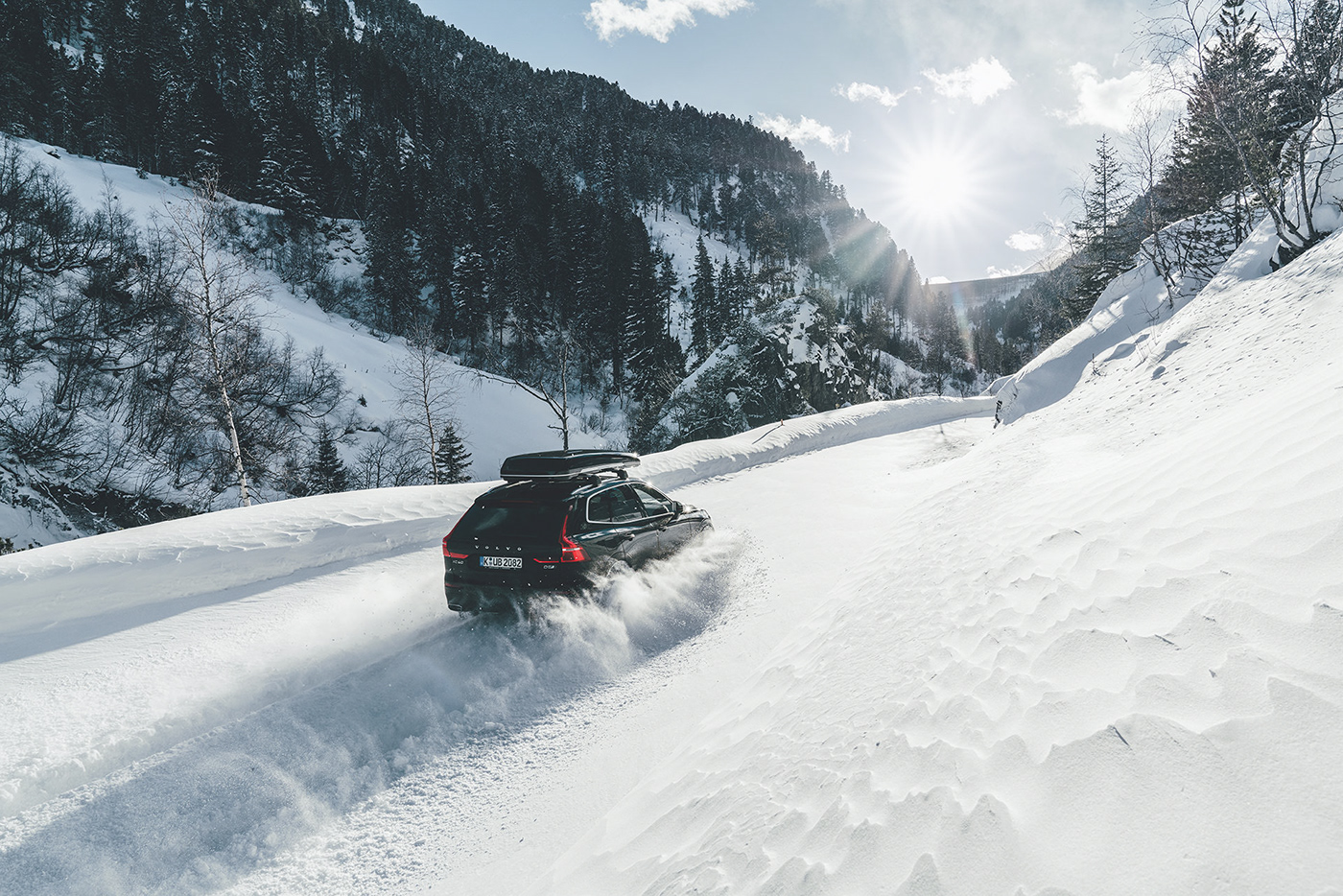 car-snow-driving-sun-mountains