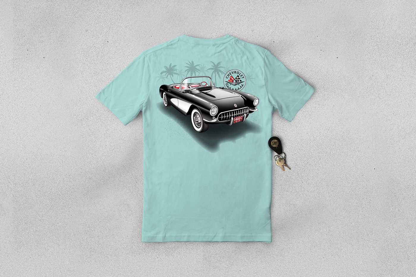 T-shirt with a 67' Corvette Stingray design laying on a sandy beach with car keys