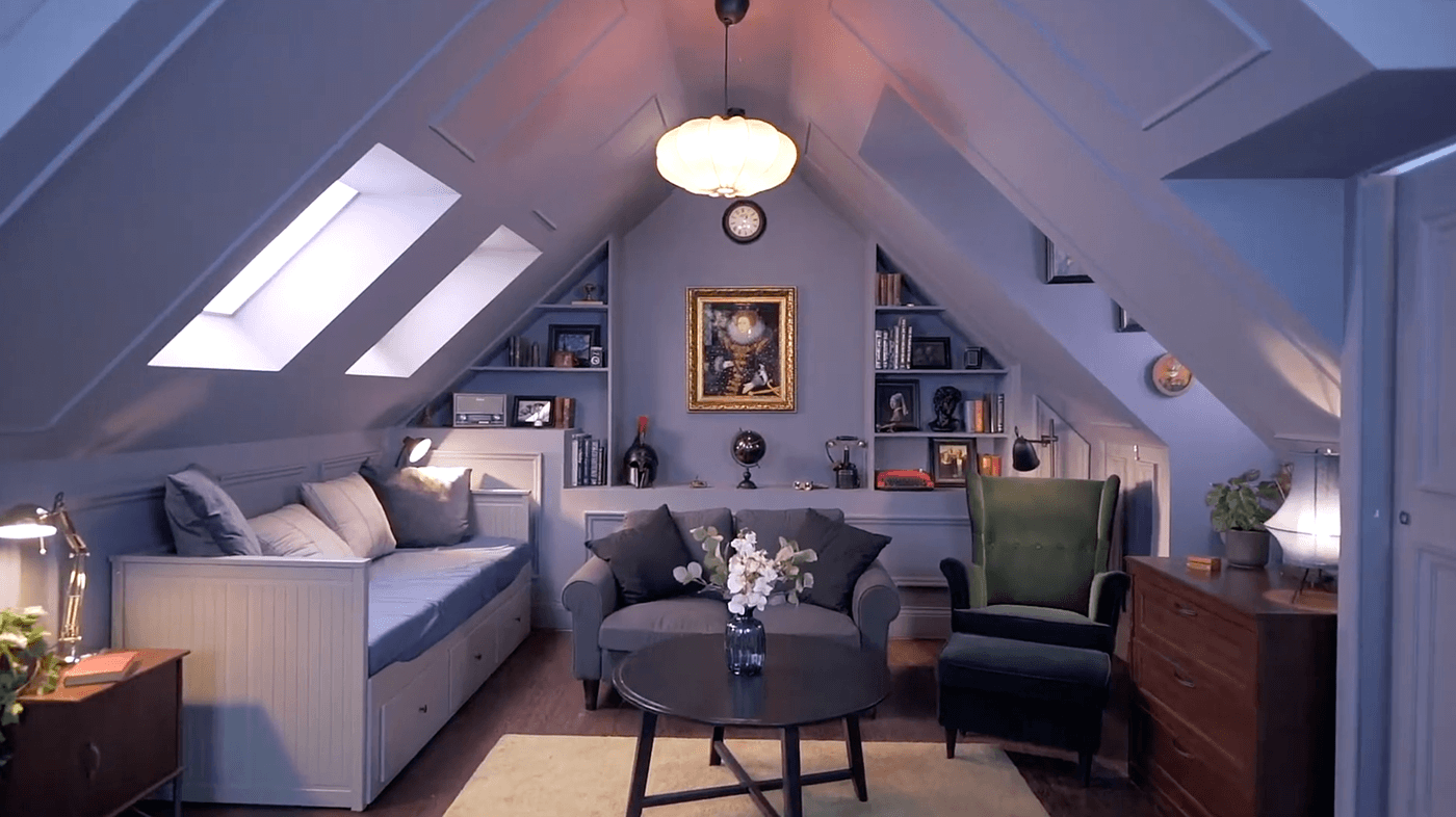 Wide shot of an attic set-up, with decorations, furniture  and propping, having blue theme