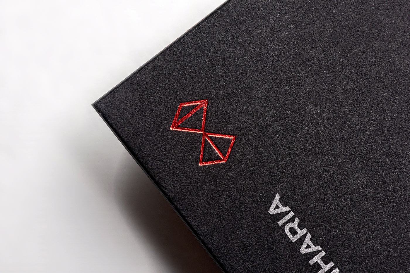 black business card zoom with red foil stamp