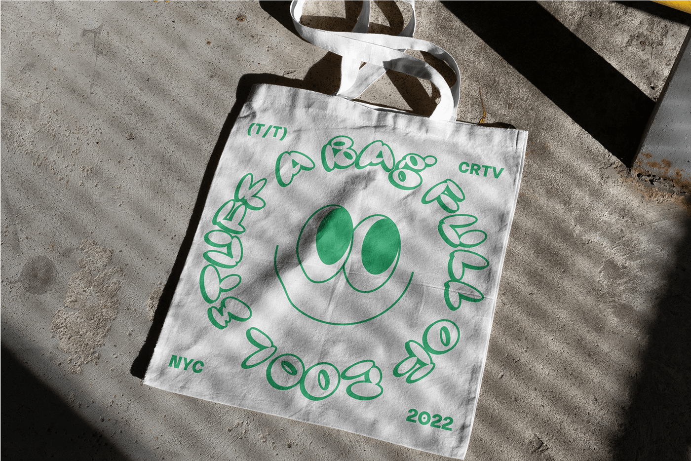 a tote bag with a smiley face that says " a bag full of cool stuff"