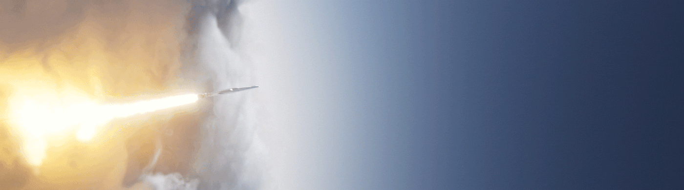Rocket blasts through the clouds in slow motion, burning a trail behind it.