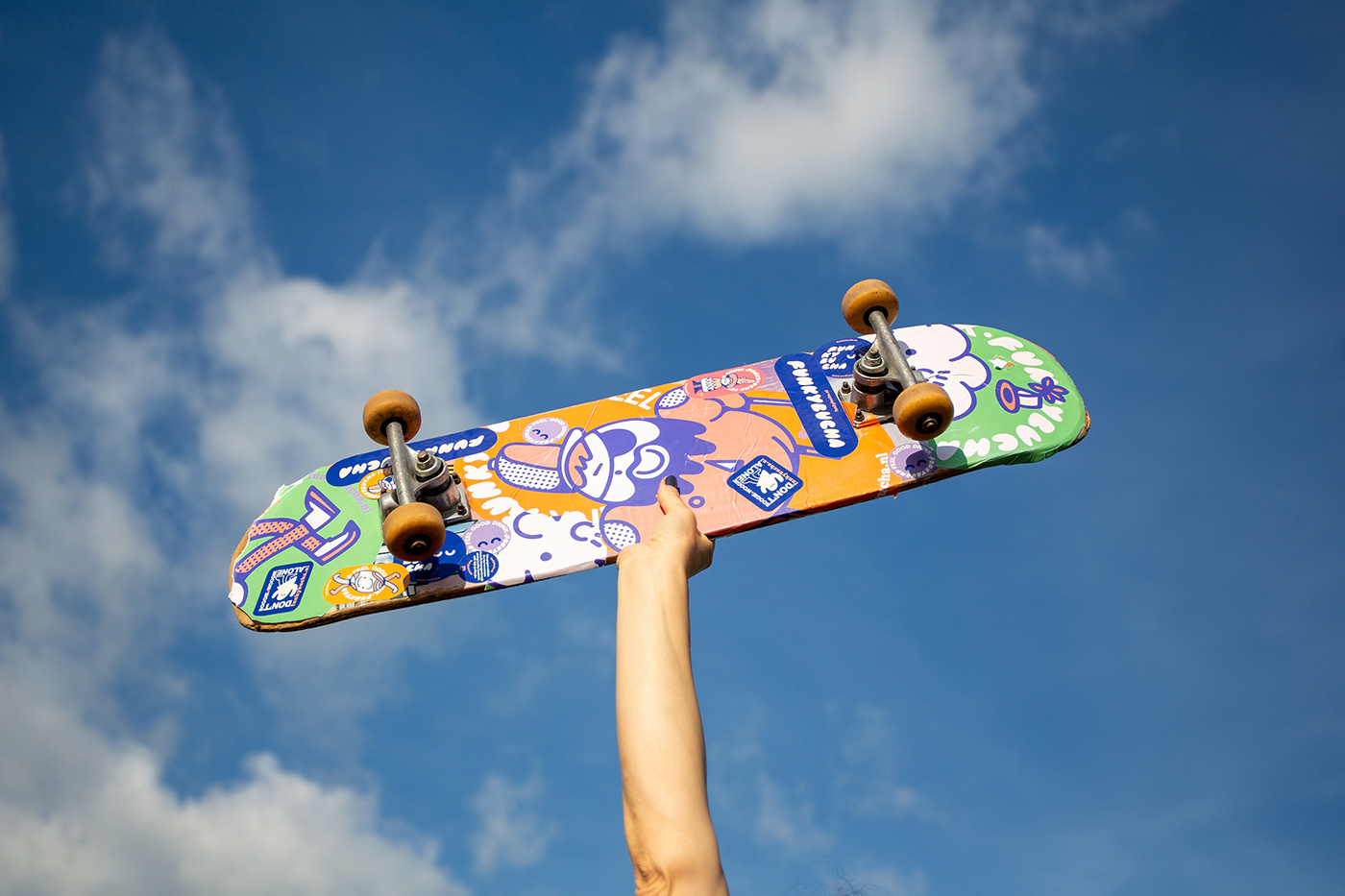 hand holding a skateboard 