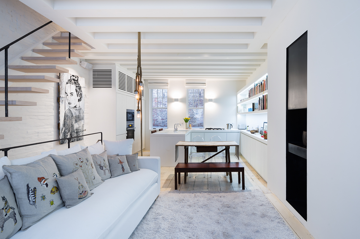 duplex Interior Renovation Bleecker Street New York Apartment cantilevered staircase Ceiling Beams exposed brick