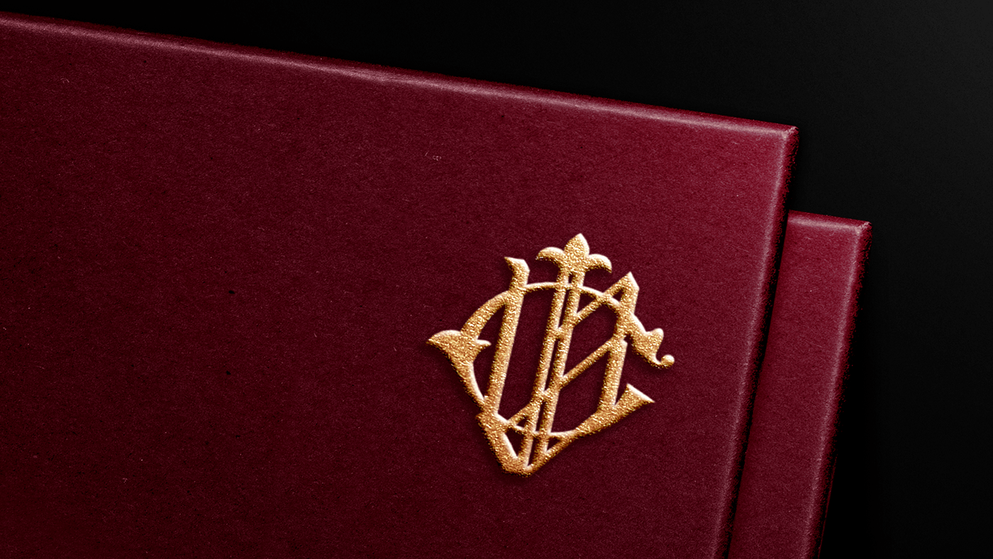 Brand symbol with embossed gold effect.