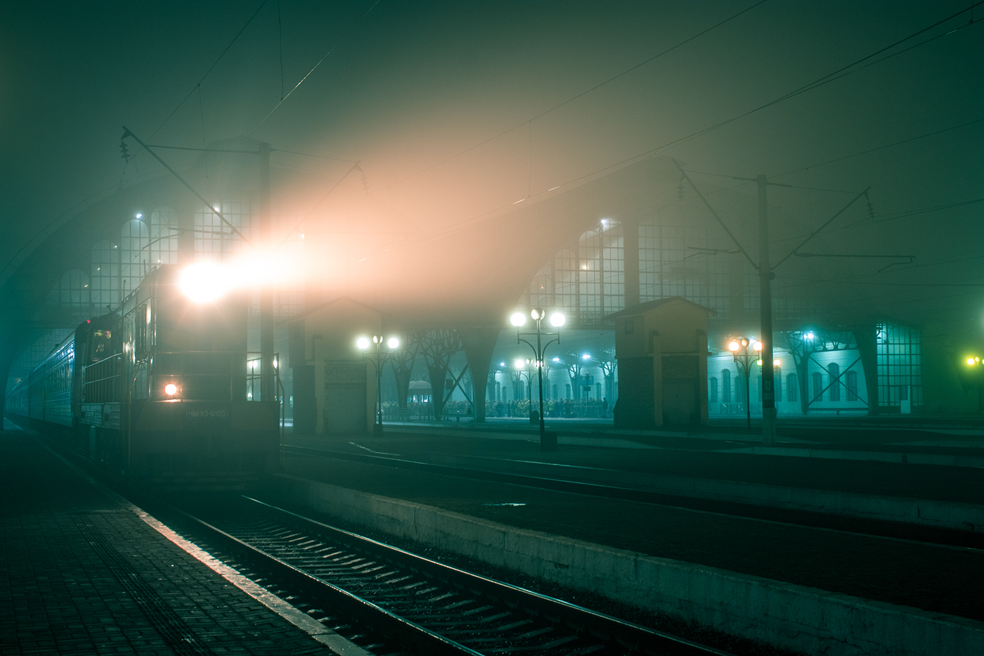 neon Lviv railway station fog night photography train lights atmosphere nightspace city