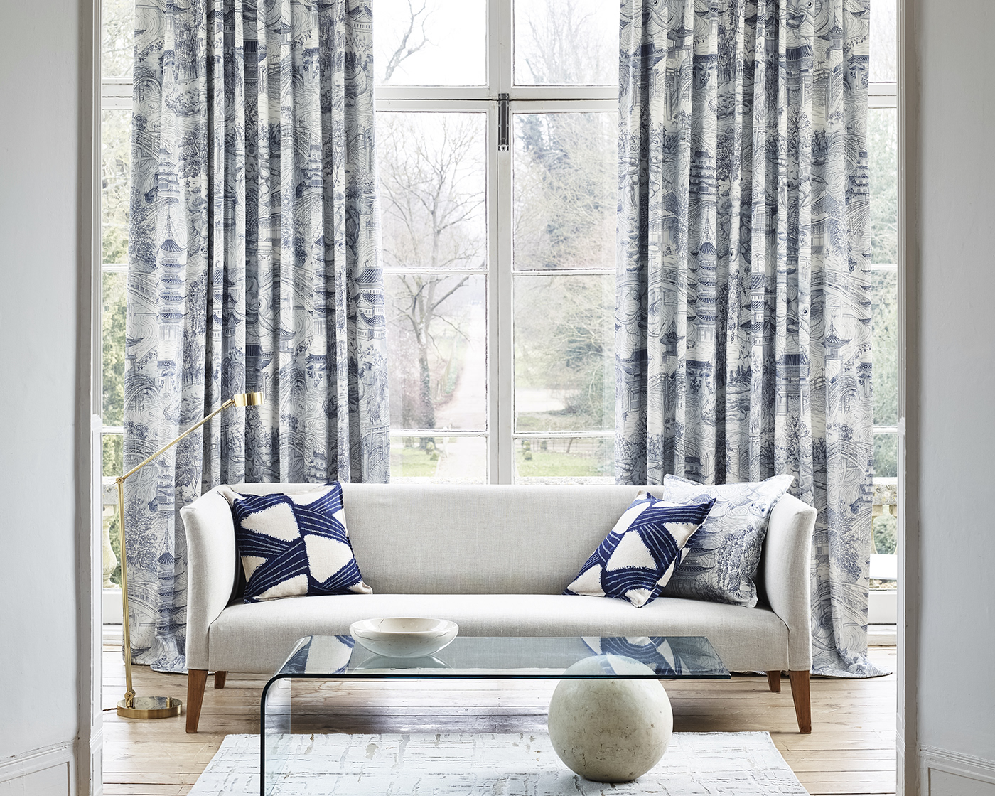 Staged interiors photograph by the Sanderson Design Group showing illustrative patterned curtains.