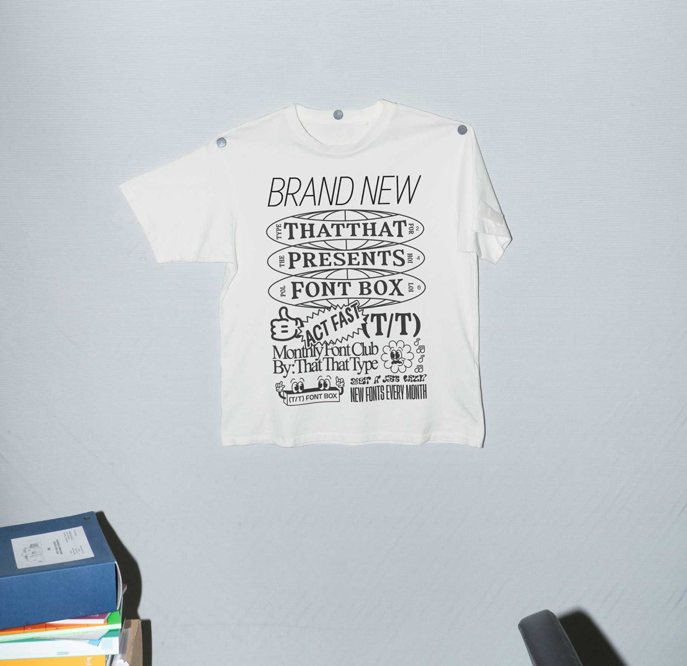 a t shirt with a heavy text graphic pinned up on a wall