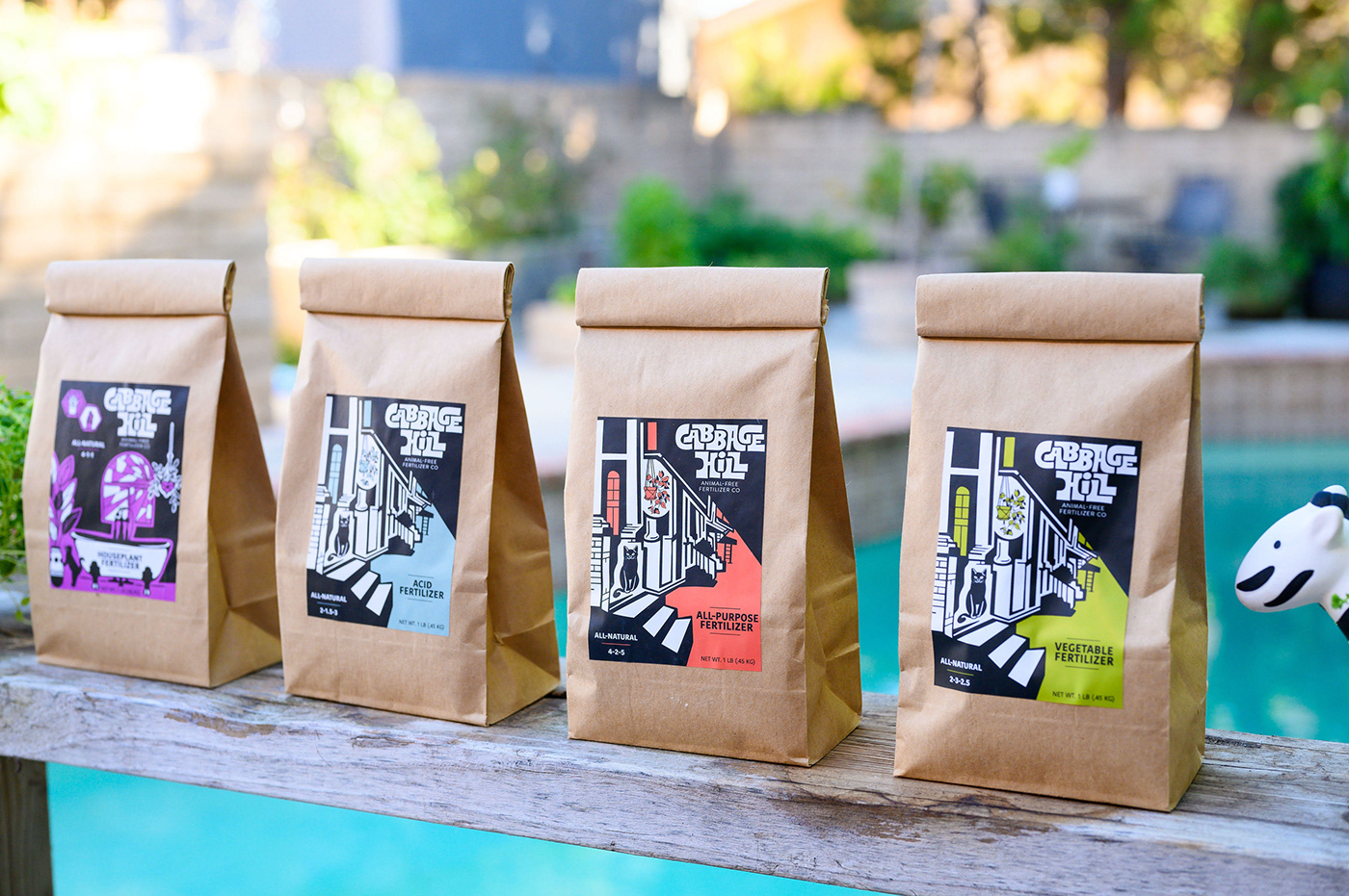Brown bags of fertilizer with label design and branding illustrations of cat.