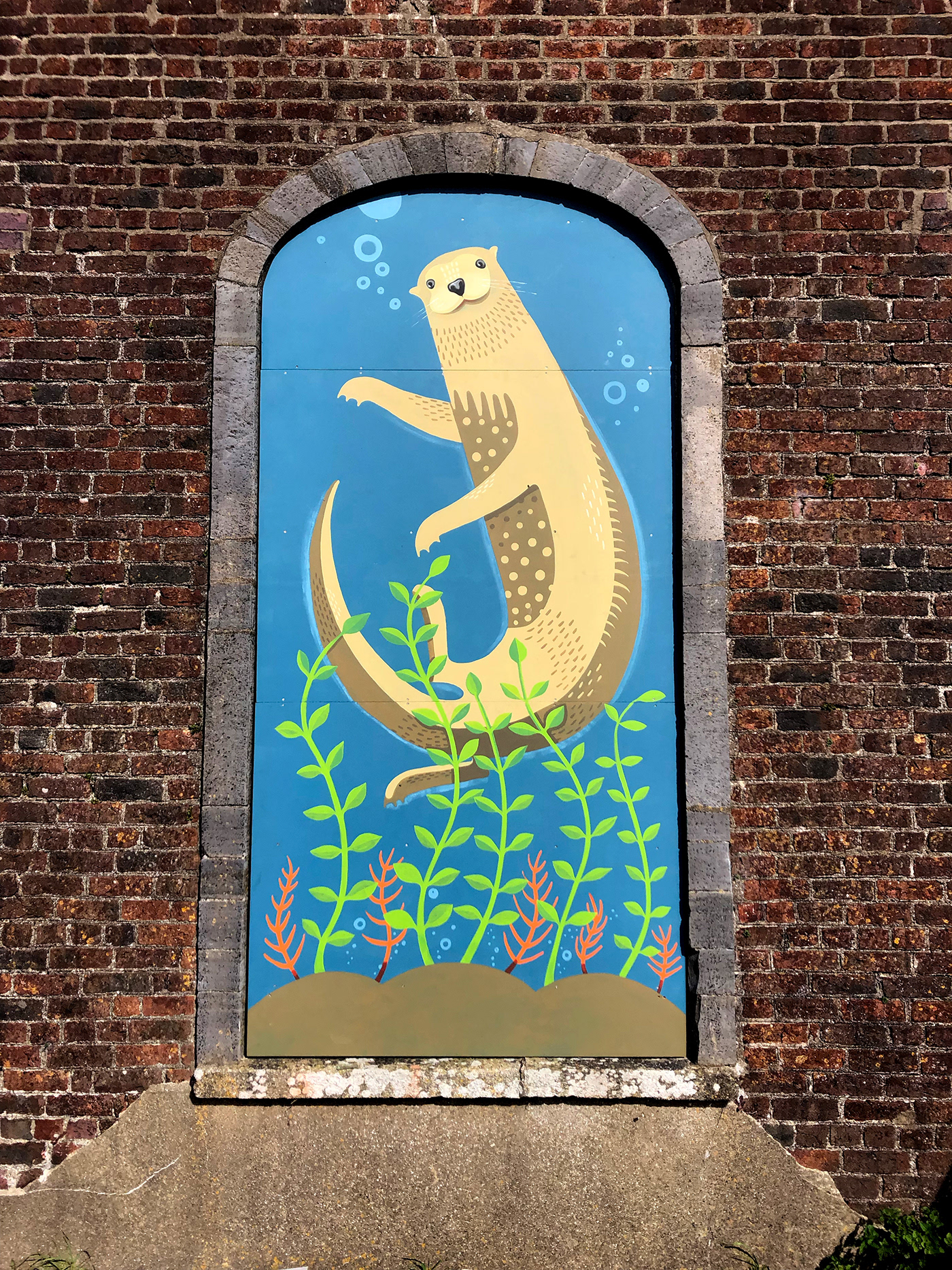 Illustration of otter swimming painted on outdoor panel for heritage building