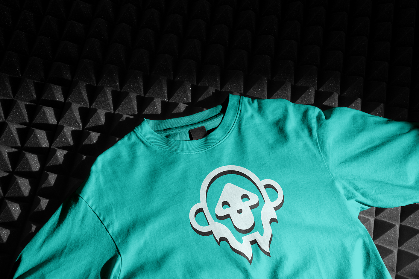 Logo of a bright teal tshirt with the MonkeyPump logo on it. 