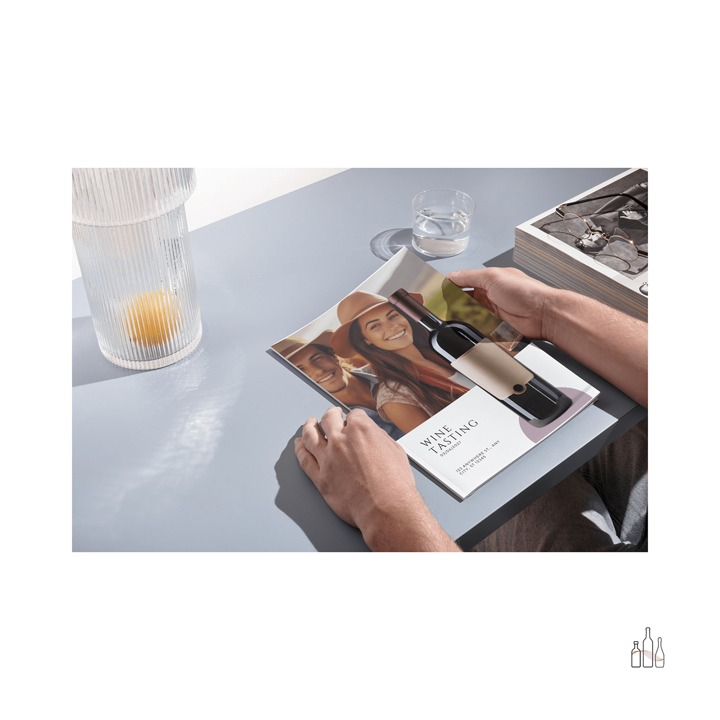 Man holding a flyer with an image of a couple in a vineyard. Mockup by Vino Visuals.