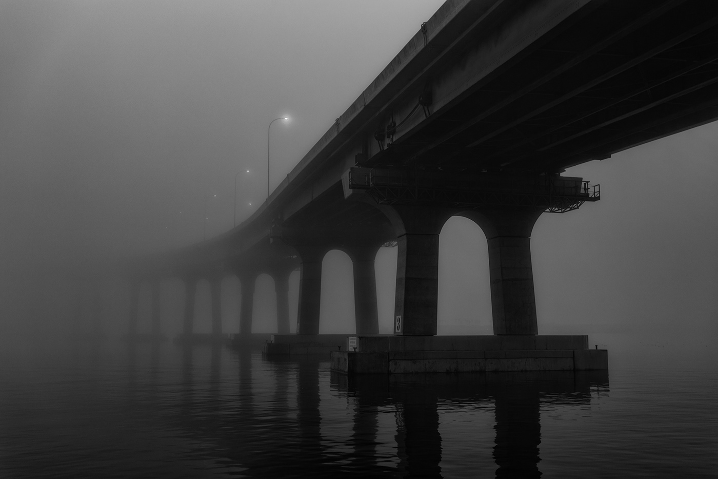 fog Moody bridge reflections Boats water night lights shoreline Still
