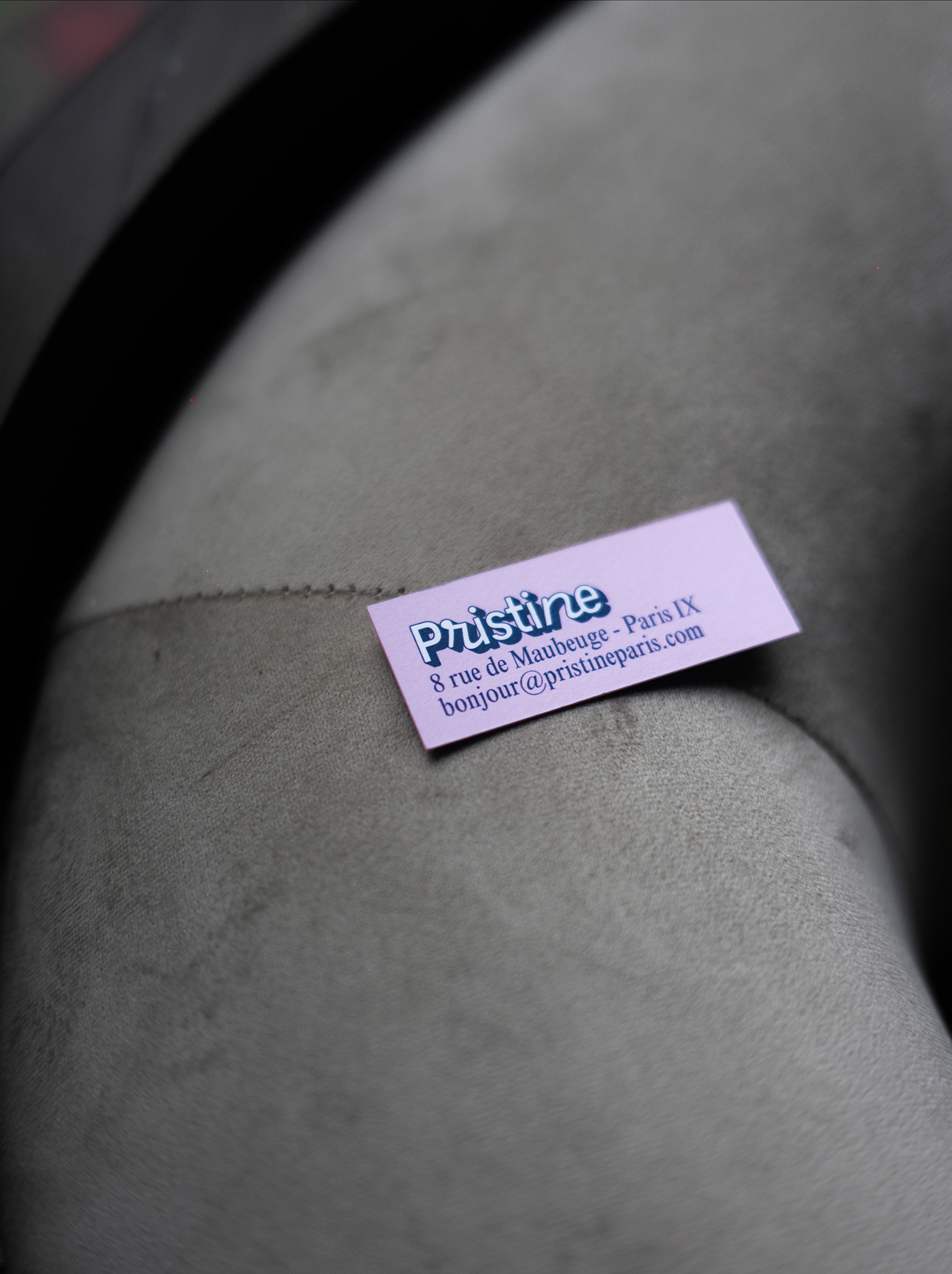 Business card disposed on design armchair