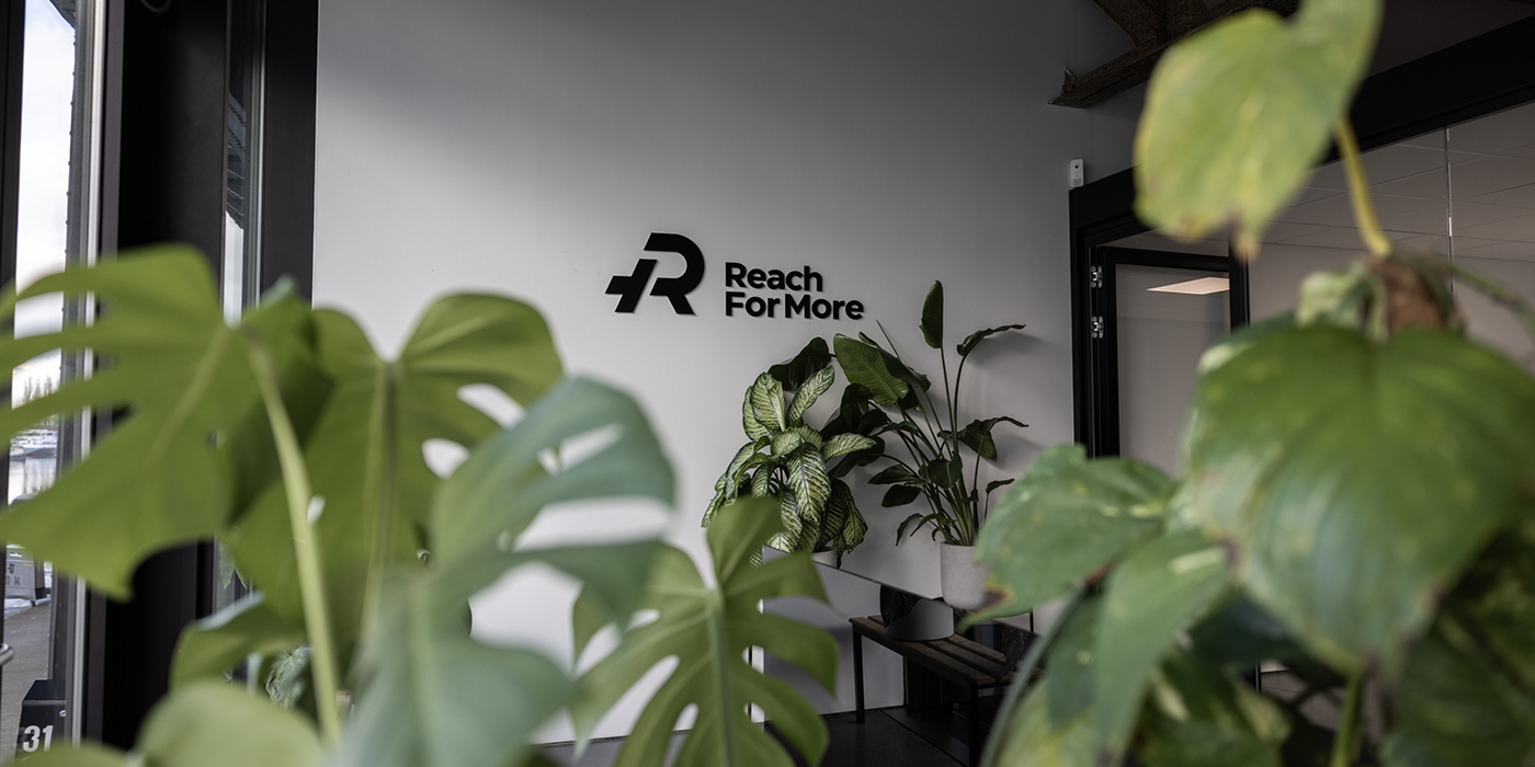 Reach For More logo sign on wall