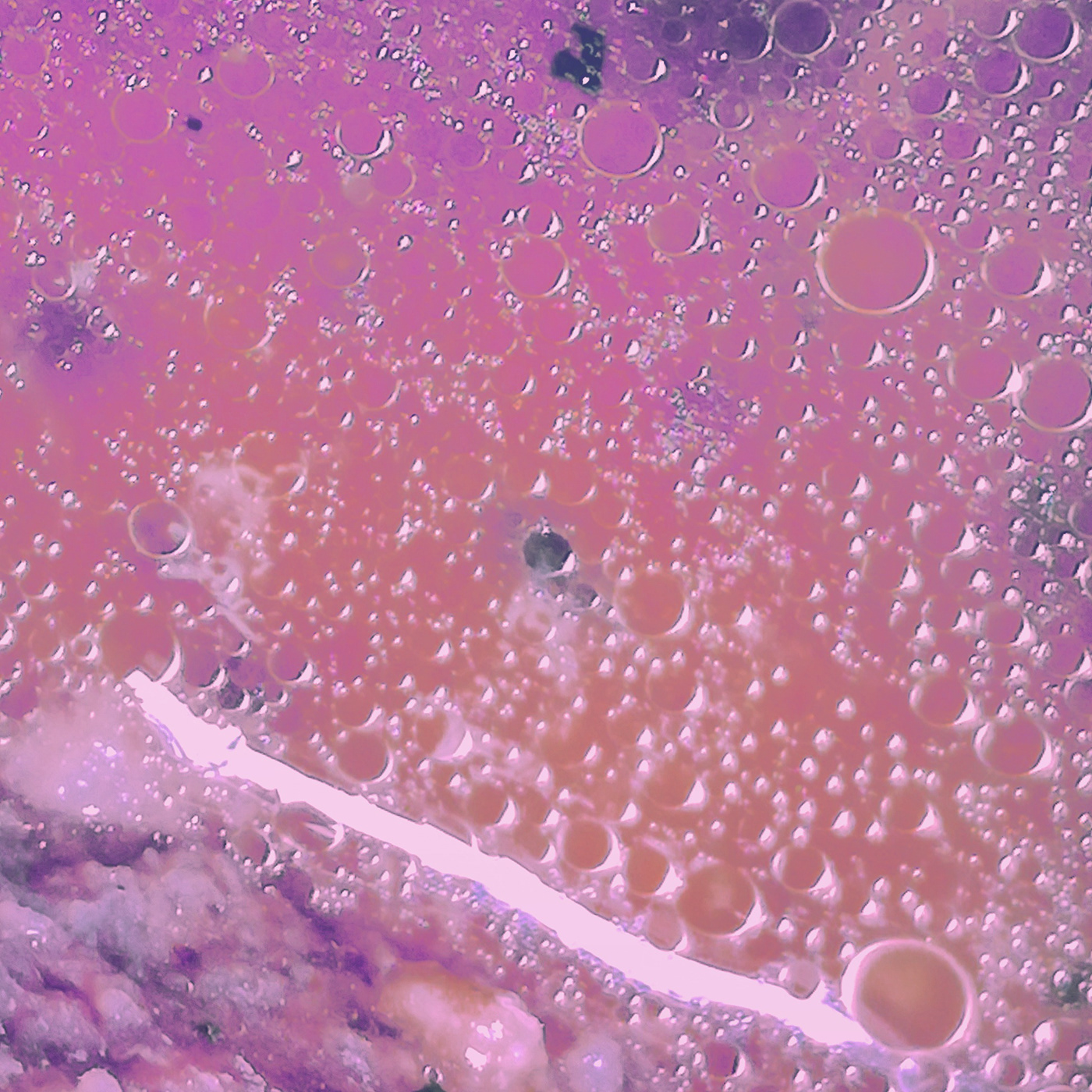 Altered pink picture of some meat juice bubbling