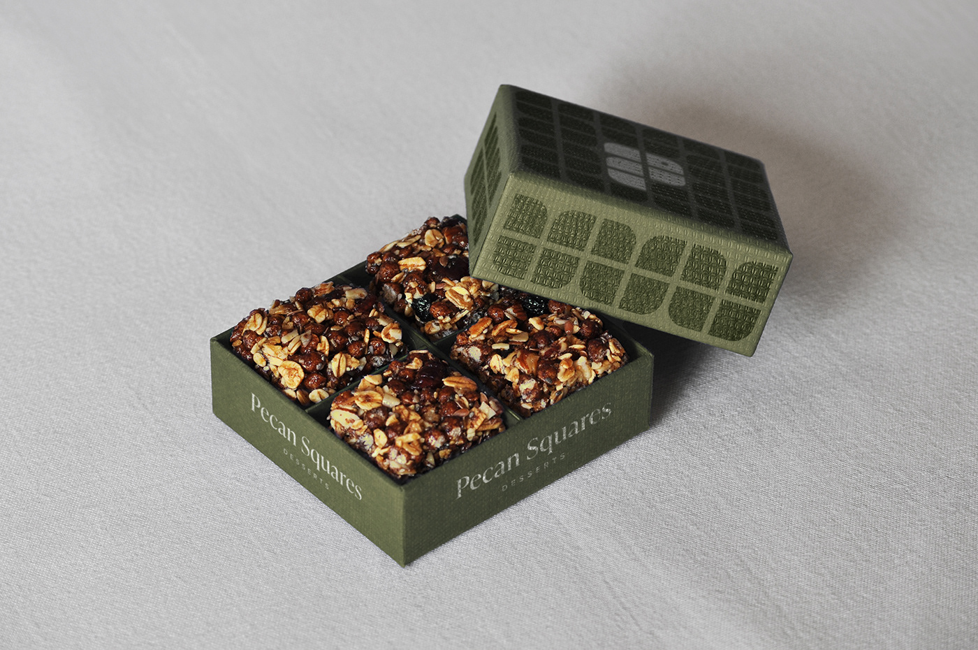An open Pecan Square package with pecan desserts inside