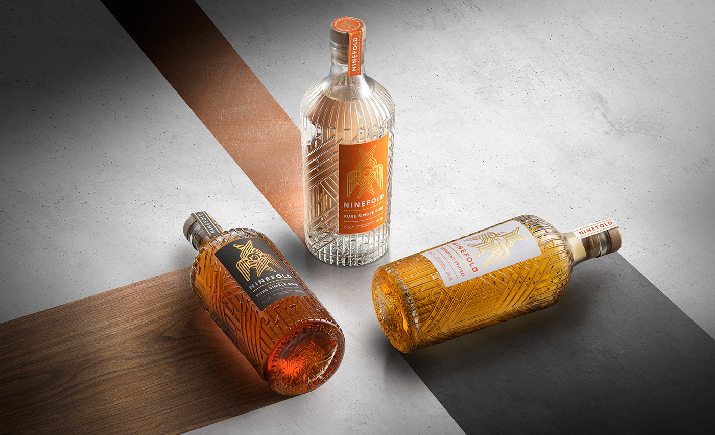 3 Bottles photographed in graphic alignment on a concrete surface