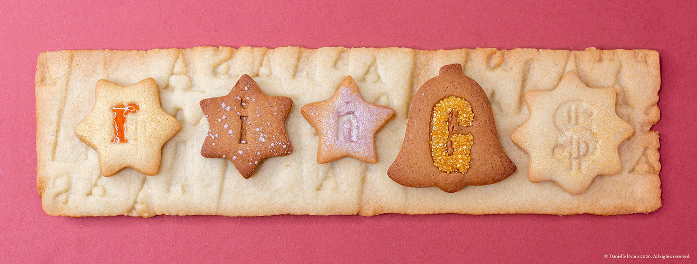 Gingerbread and sugar cookies letter pressed and filled with jam, frosting, and sprinkles.